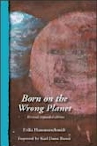 A book cover with a blue edge and a painting of two planets, a blue one overlapped by a rusty brown one with the outline of a woman's face visible in it. The title is BORN ON THE WRONG PLANET and the author is ERIKA HAMMERSCHMIDT.