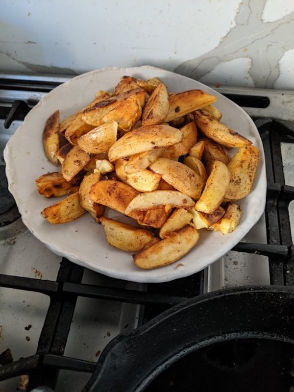 Plate of golden brown fried potato wedges