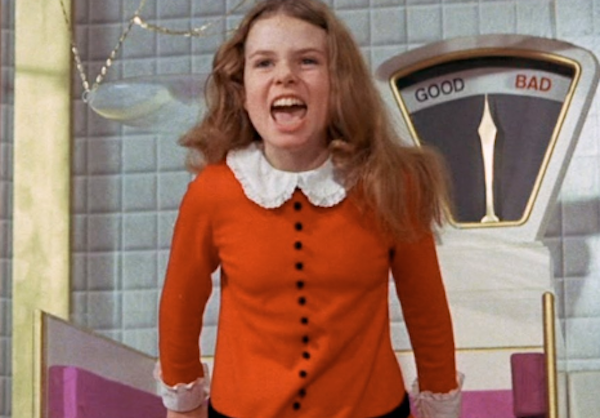 Veruca Salt in her red dress singing loudly about how she wants it all