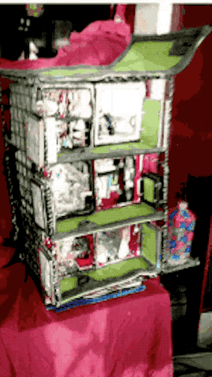 A second GIF of the same half-scale model I built of 6 apartment cubes on 3 stories of wire shelving. This animation shows the model being turned on a turntable, to show both the inner and outer sides. The resolution isn't high enough to get a clear view of the apartments, but it can be seen than the outer side is closed off, with only doors and windows showing.